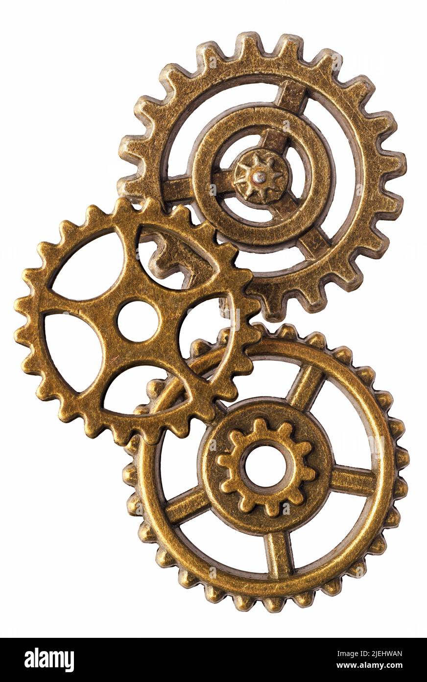 Grupo de tres ruedas dentadas de bronce, aisladas sobre fondo blanco Foto de stock