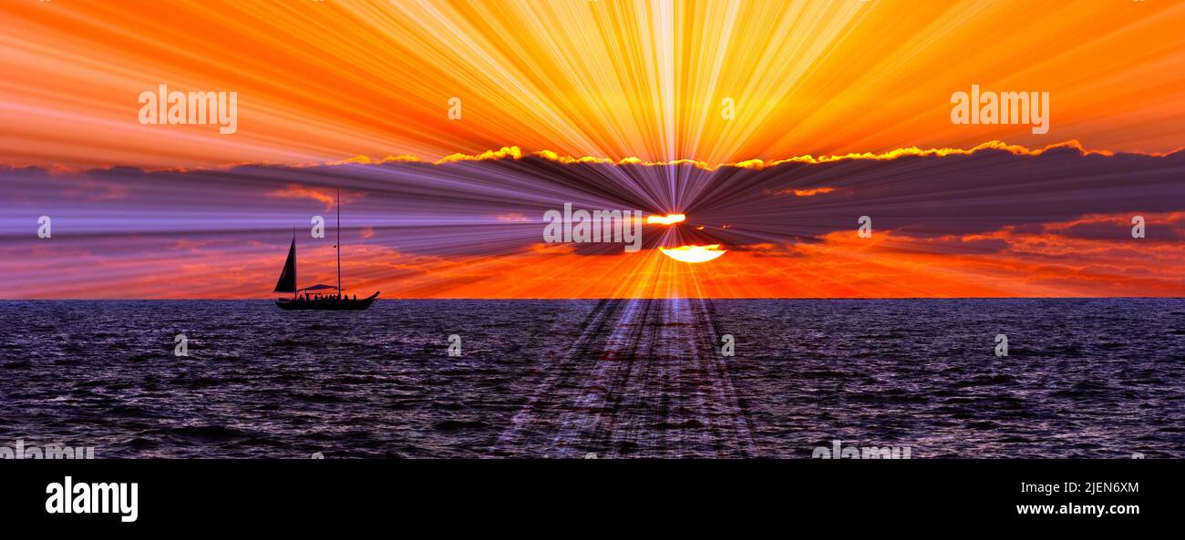 Un velero que navega por el océano mientras los rayos del sol reventan en formato de imagen de banner Foto de stock