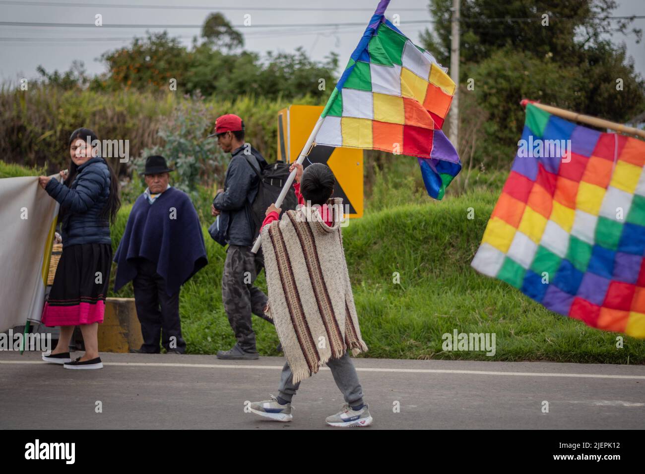 Niño que sostiene la bandera de los pueblos indígenas whipala. Ipiales, Nariño. Foto de stock