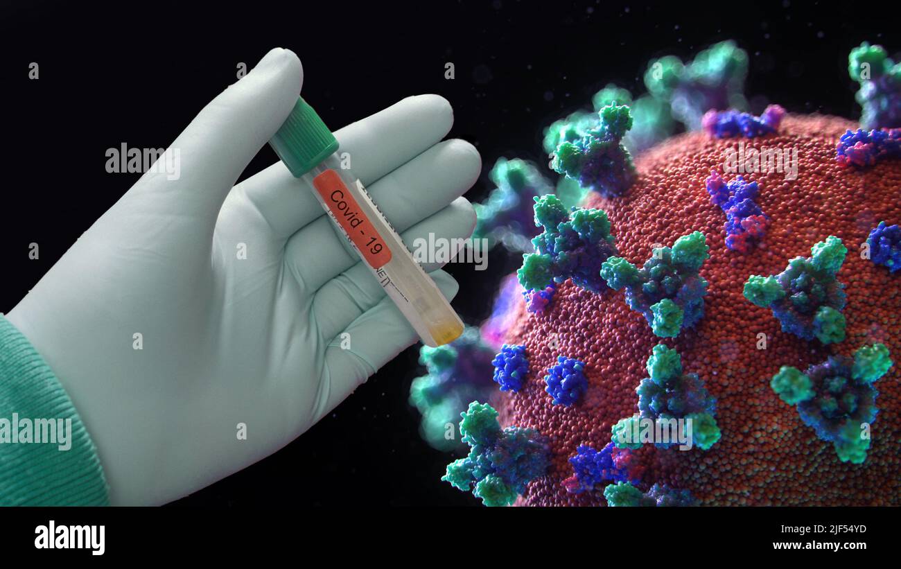 La mano sostiene la vacuna Covid 19 con célula vírica Foto de stock