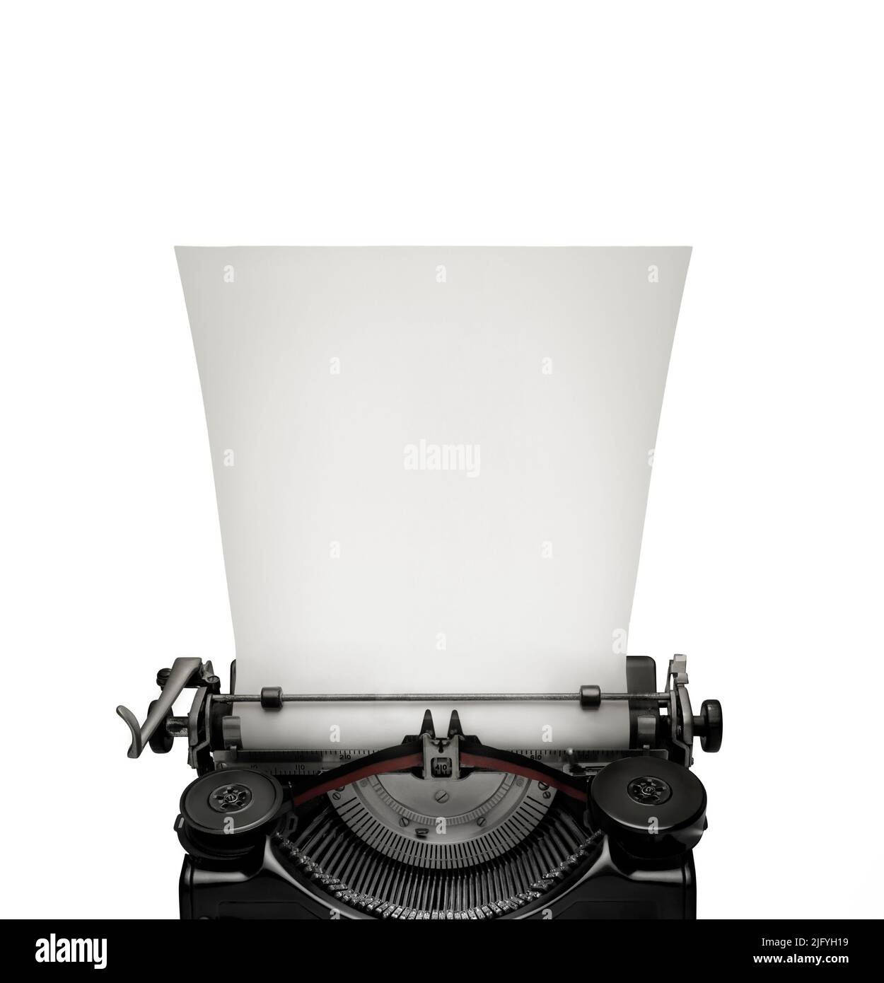 Vintage con máquina de escribir una página en blanco contra el fondo blanco. Espacio para el texto en la página en blanco. Foto de stock