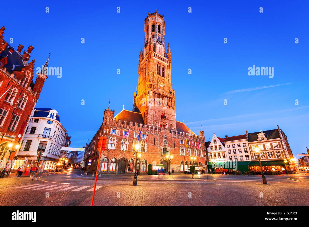 Brujas, Bélgica. Paisaje de hora azul con la famosa torre Belfry y edificios medievales en Grote Markt, Flandes. Foto de stock