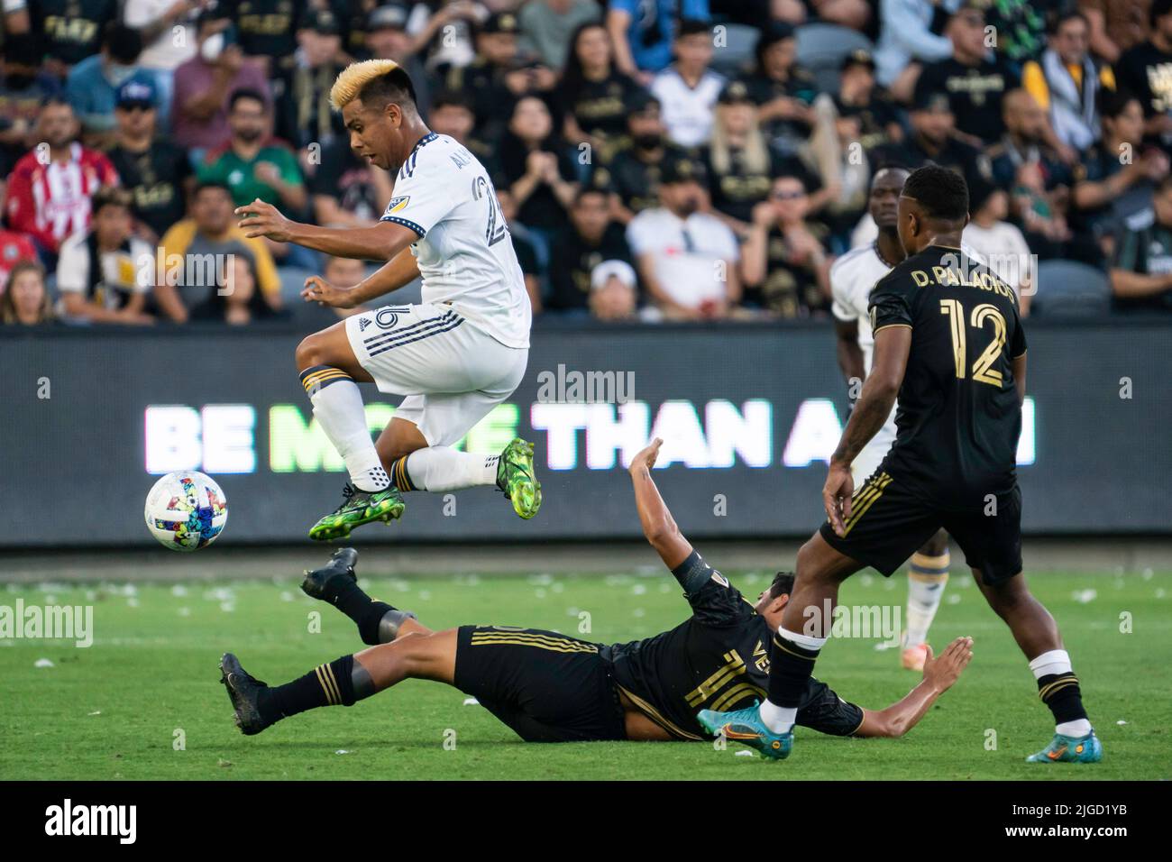 La centrocampista DE LA Galaxy Efrain Álvarez (26) evita un tackle de  diapositivas del delantero de la LAFC Carlos Vela (10) durante un partido  de la MLS, viernes 8 de julio de