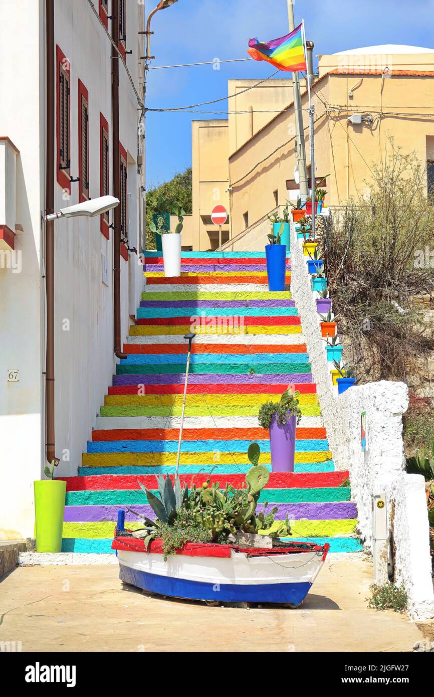 Escalera de color que conduce desde la ciudad hasta el puerto antiguo. Lampedusa, Italia - Agosto de 2019 Foto de stock