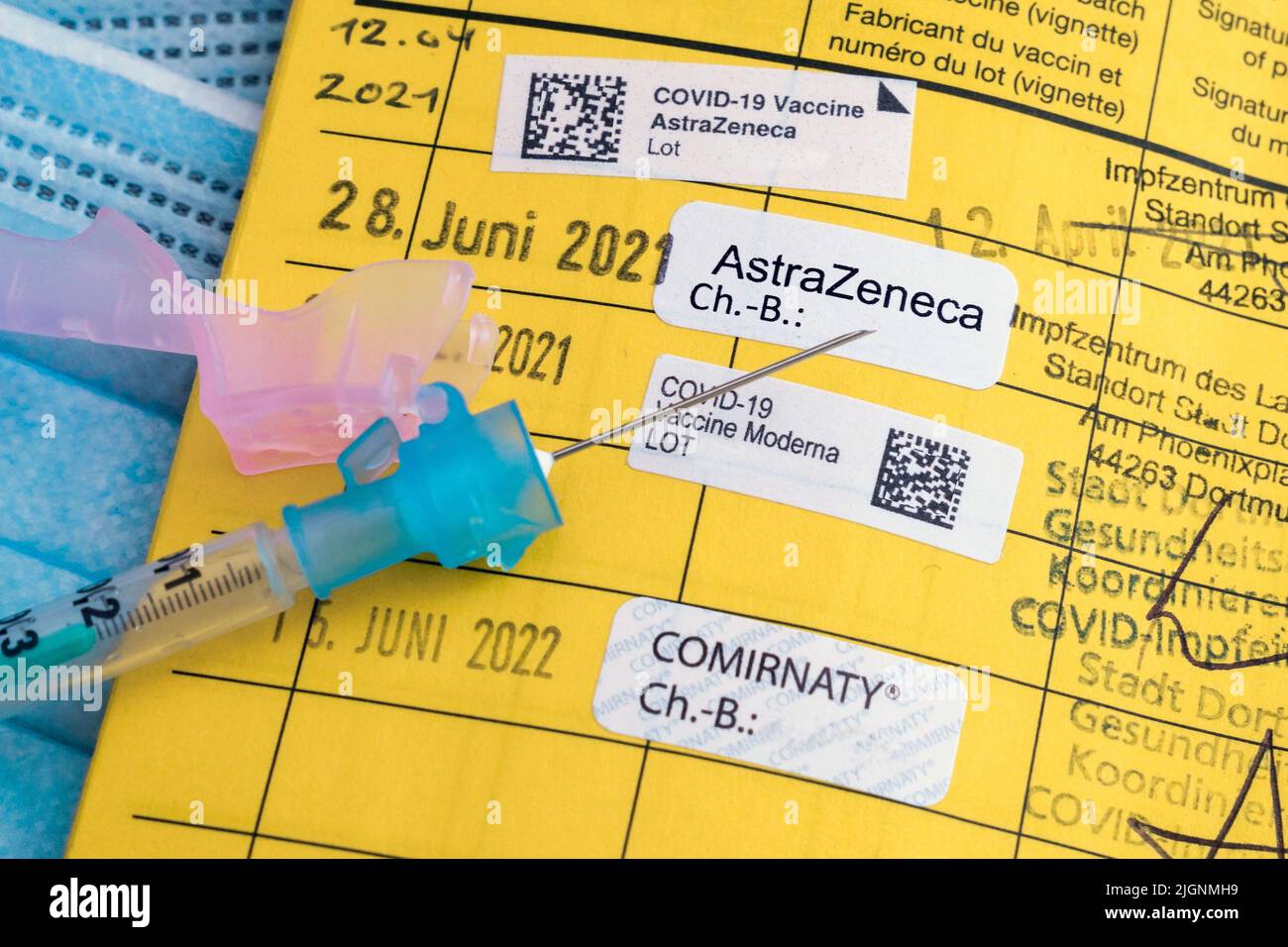 Jeringa en una tarjeta de vacunación alemana con la nota de cuatro vacunas contra Covid-19, vacunación de refuerzo - 07/12/2022 Foto de stock
