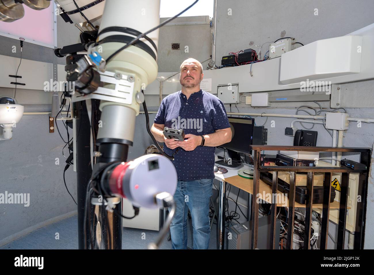 Salvador Ribas, director del Centro de Observación del Universo, maniobrando un telescopio en el Parque Astronómico del Montsec, en Àger (Lleida, Cataluña) Foto de stock