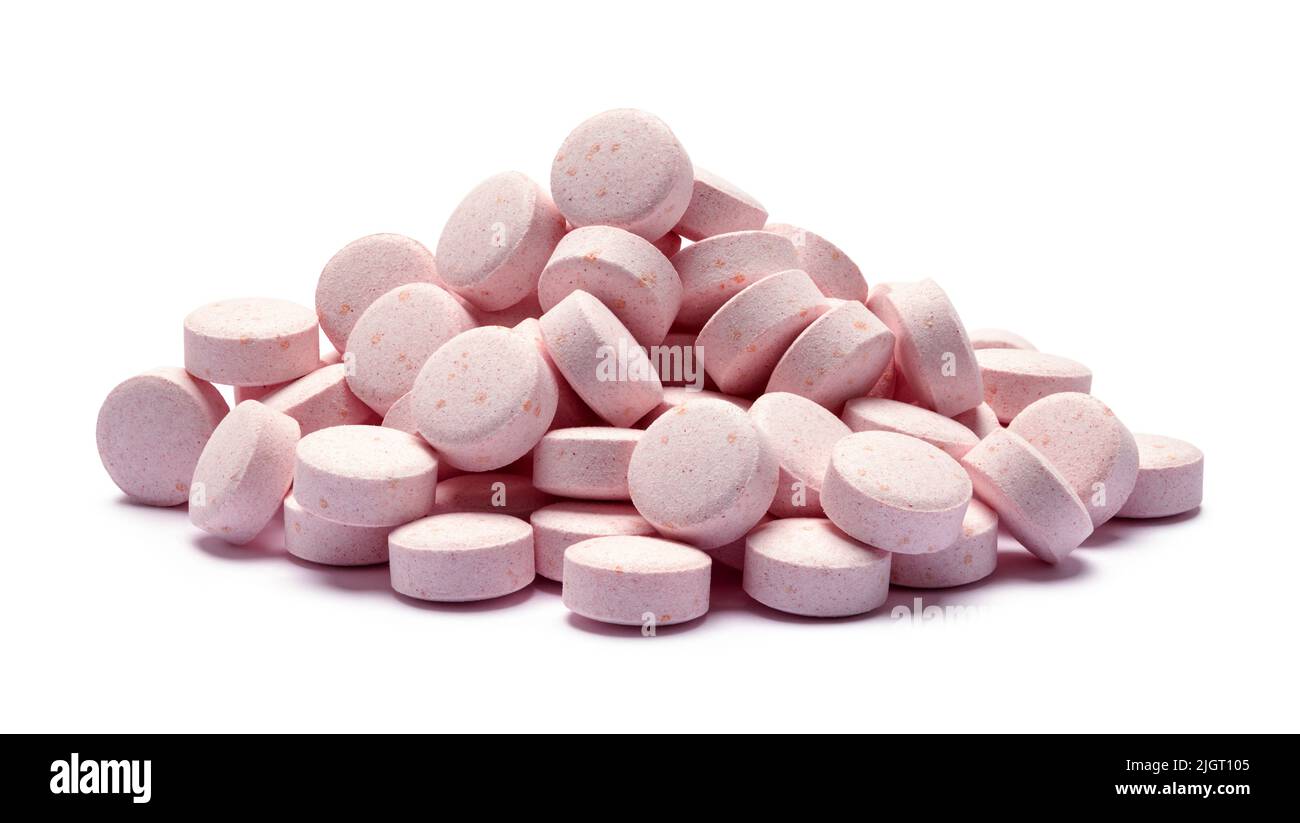 Pila de píldoras de medicina rosa Corte en blanco. Foto de stock