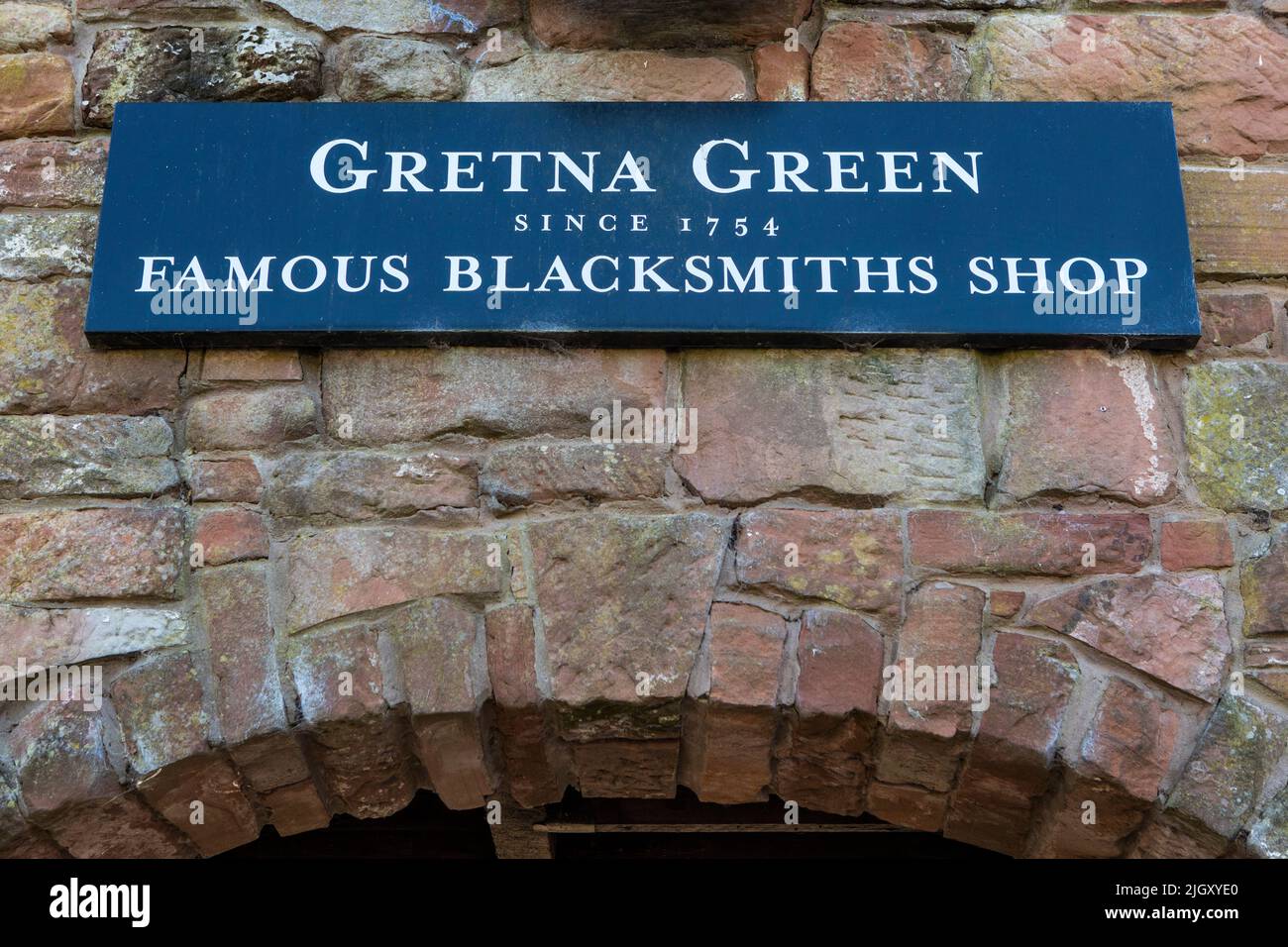 Gretna Green, Escocia - Octubre de 15th 2021: Una señal que señala a los visitantes a la dirección de la famosa tienda de herreros en Gretna Green, Escocia. Foto de stock