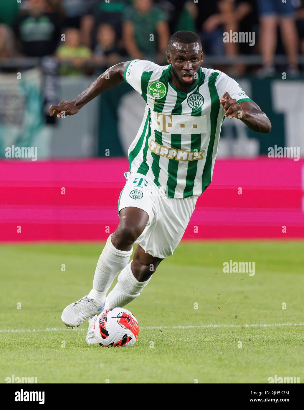 Anderson Esiti of Ferencvarosi TC challenges Luis Jakobi of Ujpest