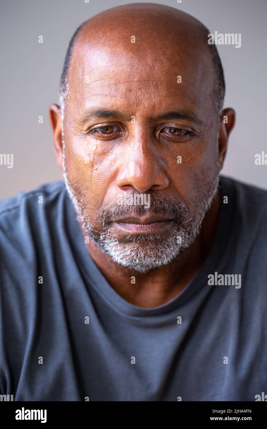 Hombre africano americano maduro en pensamiento profundo mirando infeliz. Foto de stock