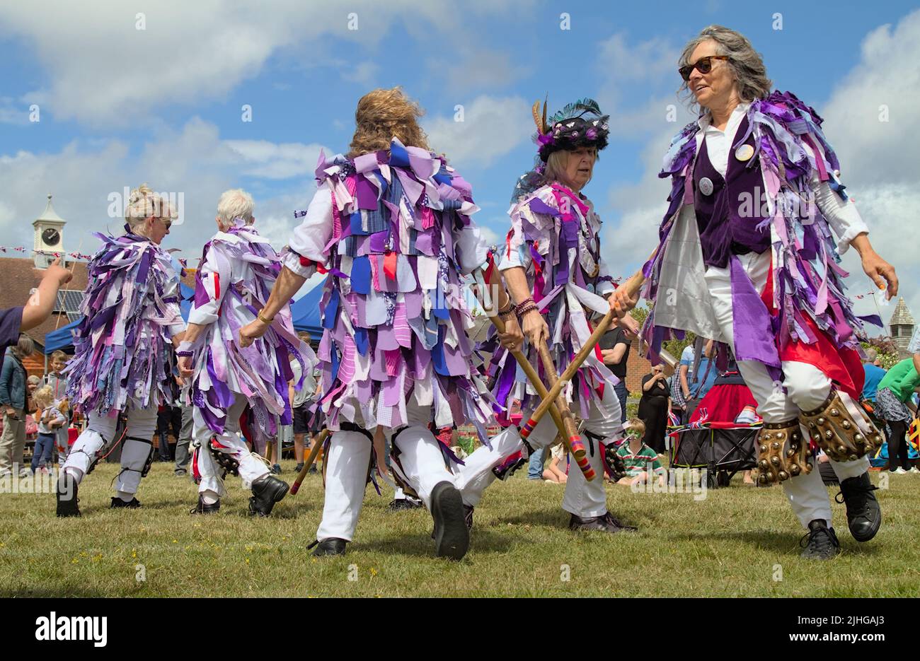 Morris Dancers in Clothes Made of Purple Rags Dancing with Sticks, New Forest UK Foto de stock