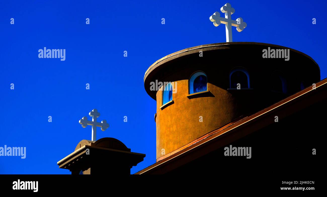 Campanario con blanco cruz cristiana con el cielo azul Foto de stock