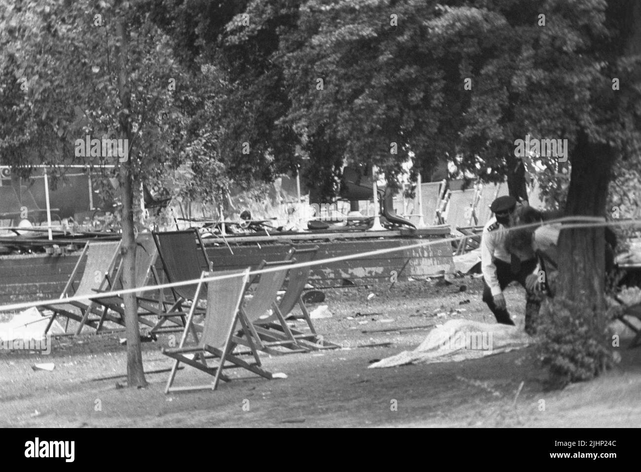 Foto de archivo de fecha 20/7/1982 de la policía examinando un cuerpo cubierto por una manta cerca del devastado stand de la banda en Regent's Park, Londres, después de una explosión de una bomba del IRA. Las familias de los soldados muertos en los atentados con bombas del IRA en Hyde Park y Regent's Park han dicho que su sufrimiento sigue sin disminuir 40 años después. En total, 11 militares murieron en los dos ataques que tuvieron lugar a pocas horas en Londres el 20 1982 de julio. Fecha de emisión: Miércoles 20 de julio de 2022. Foto de stock