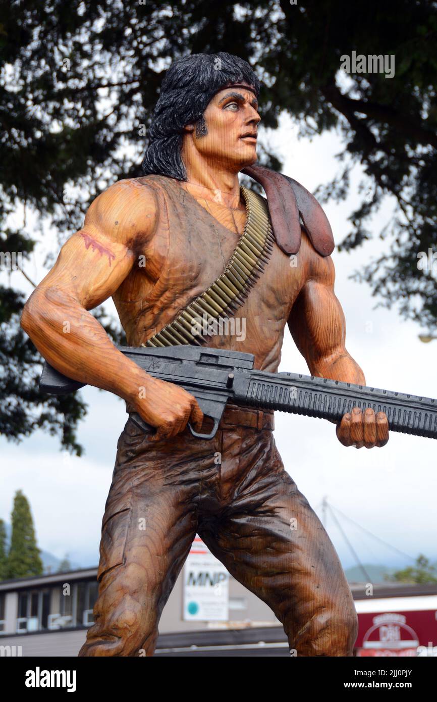 Una estatua de madera que muestra el personaje John Rambo, interpretado por Sylvester Stallone, de las primeras películas Blood/Rambo, In Hope, British Columbia, Canadá. Foto de stock