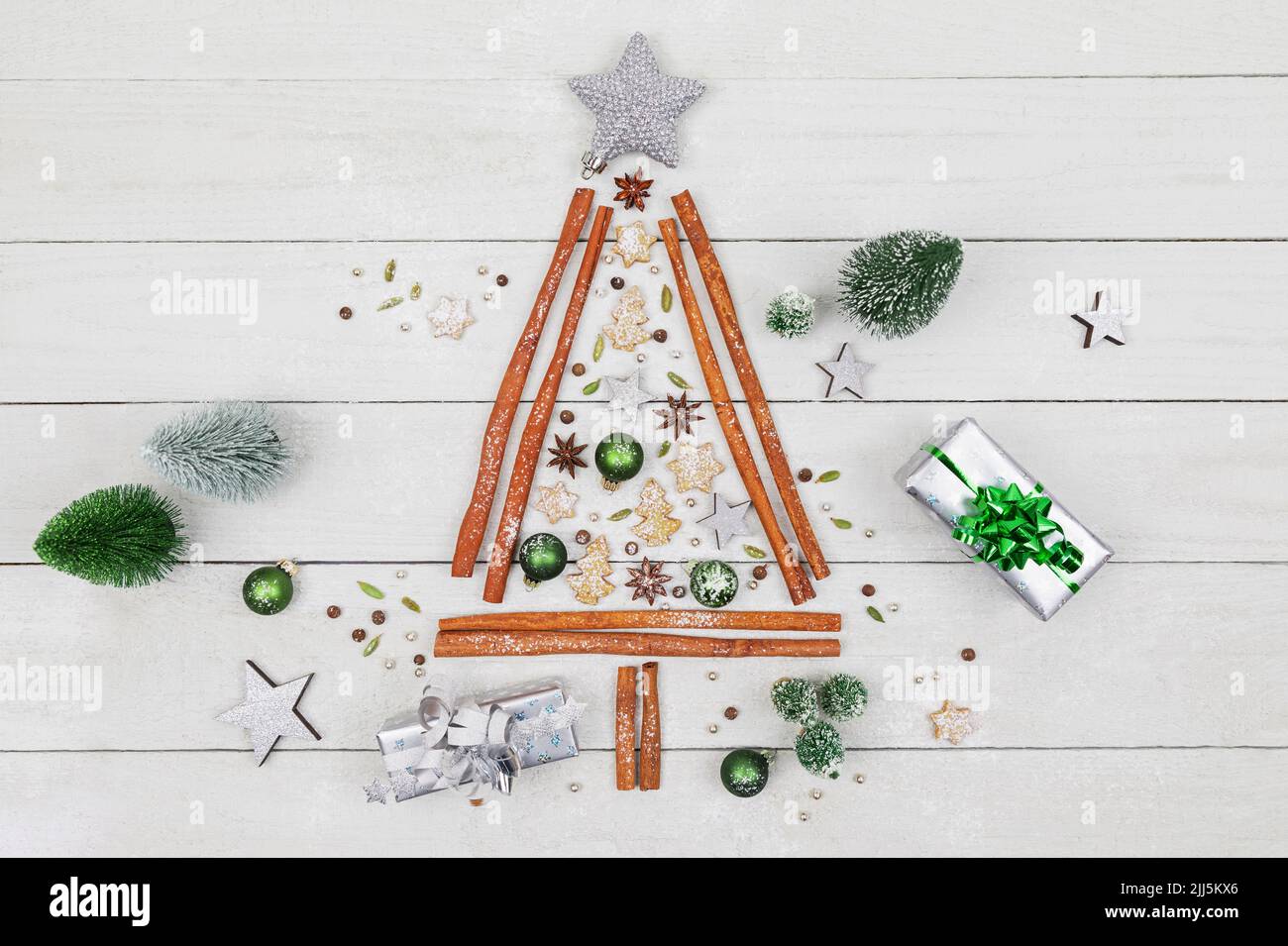 Toma de estudio con forma de árbol de Navidad hecha de varias especias, galletas y adornos de Navidad Foto de stock