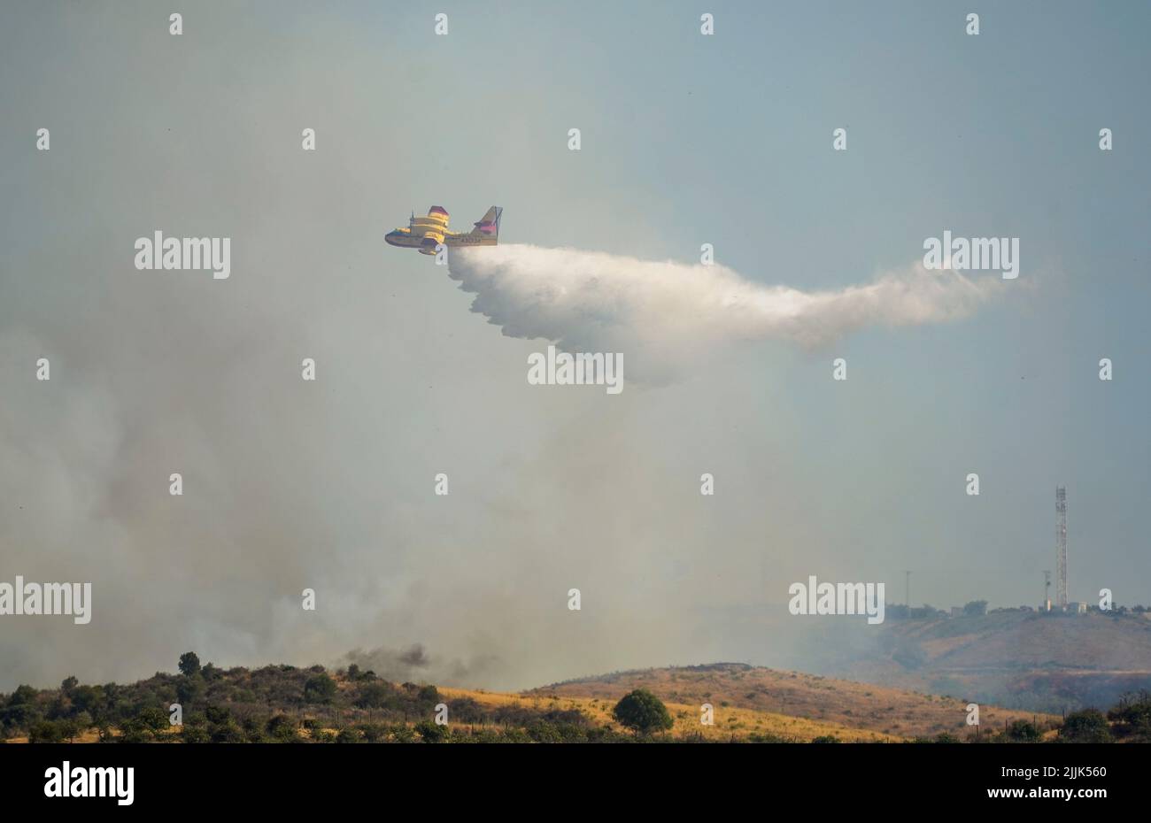 Avión anfibio que cae agua sobre los incendios forestales en el campo de Mijas, Mijas, Andalucía, España. Foto de stock
