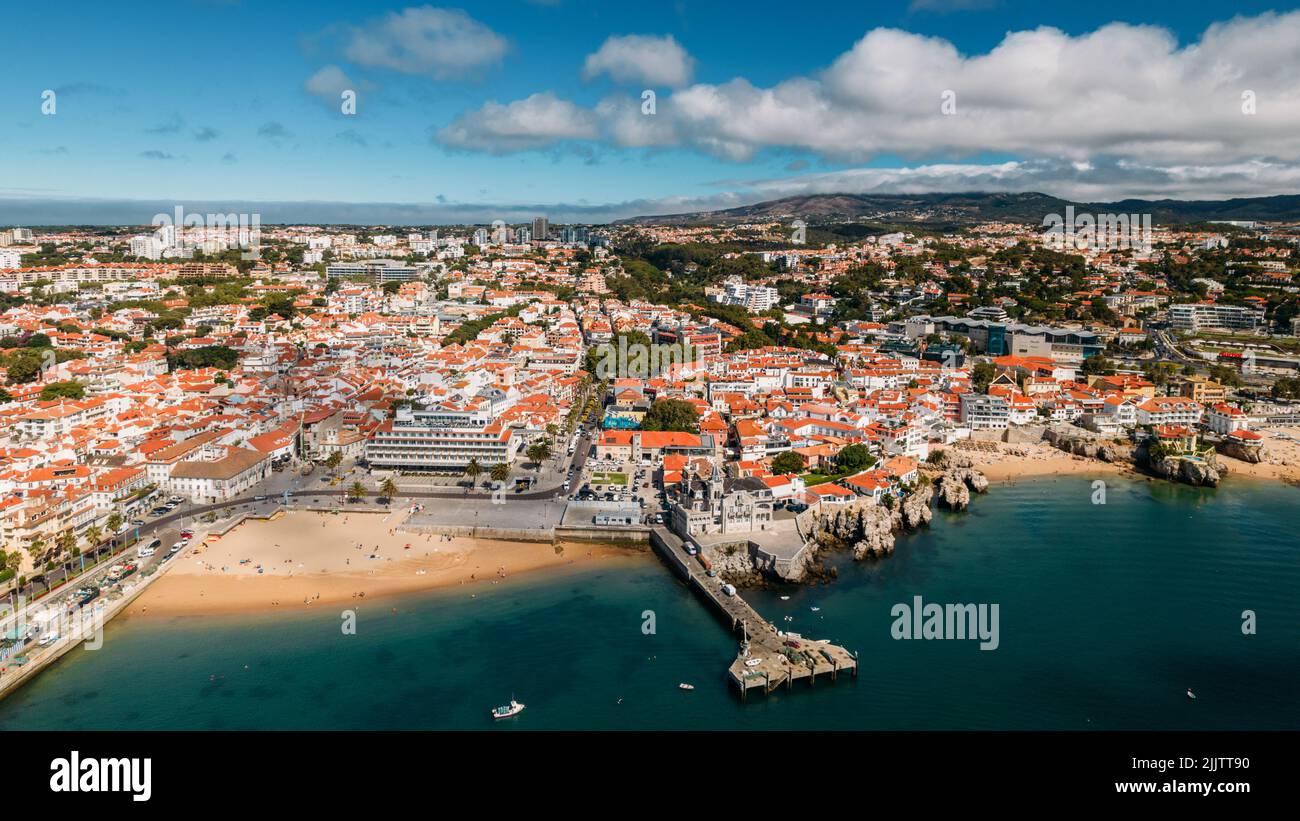 Vista aérea del zumbido panaromático de la bahía de Cascais, Portugal mirando hacia la playa de Ribeira con las montañas de Sintra en el fondo Foto de stock