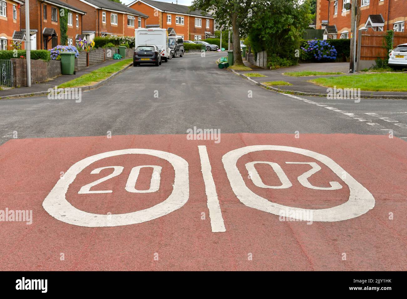 Llantrisant, Gales - Julio de 2022: Marcas de carretera que muestran una velocidad limitada de 20 mph pintado en la calle a la entrada de una finca de viviendas. Foto de stock