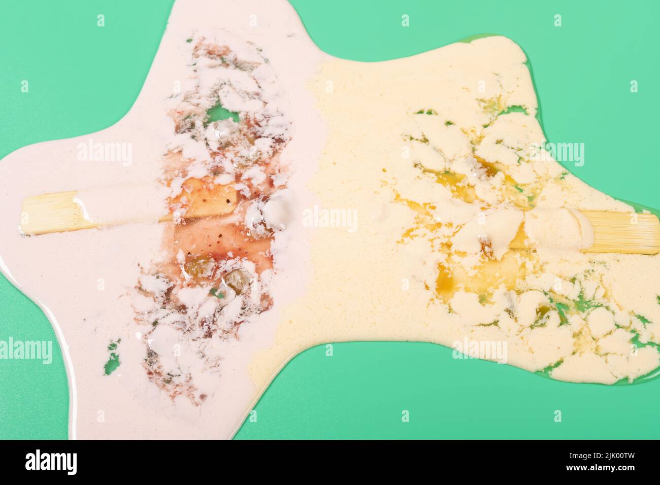 ángulo de visión fresas y sabores de mango paletas fundidas sobre un fondo verde Foto de stock