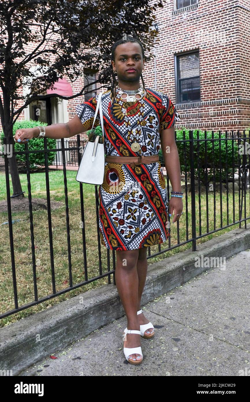 Posó retrato de una mujer trans con un vestido con un patrón keniano. En 83rd Street en Jackson Heights, Queens, Nueva York. Foto de stock