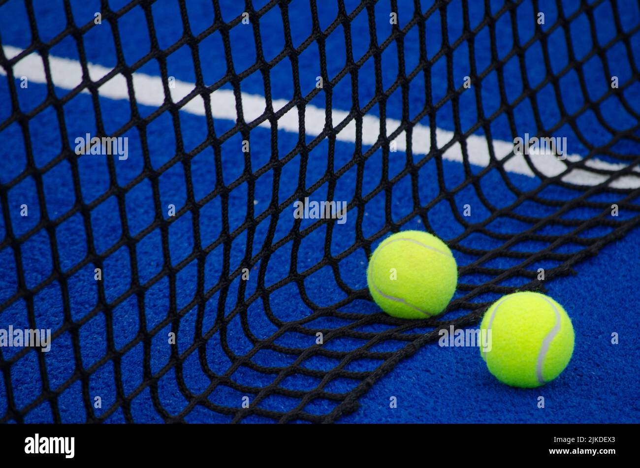 enfoque selectivo, pádel pelotas de tenis en una pista de paddle azul cerca  de la red Fotografía de stock - Alamy