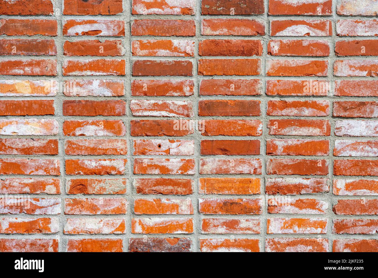 Fondo de una pared hecha de ladrillos de clinker rojos Foto de stock