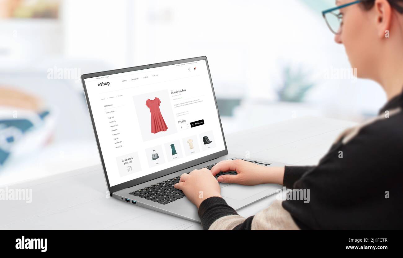 Mujer de compras en línea con portátil. Concepto de la compra de ropa de mujer en línea en los sitios web de comercio electrónico Foto de stock
