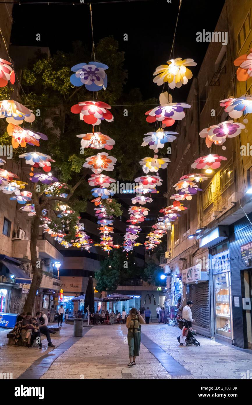 Coloridas flores de papel están suspendidas sobre una calle peatonal en Jerusalén Oeste Israel Foto de stock