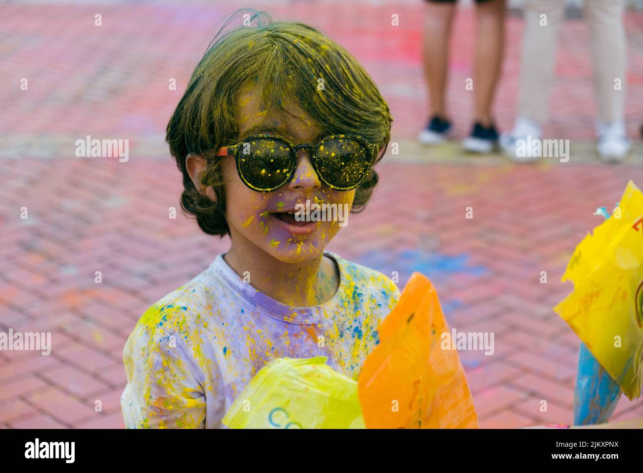 Festival de Holi. Jóvenes alegres bajo la explosión de polvo de color en Holi colors partido. Foto de stock