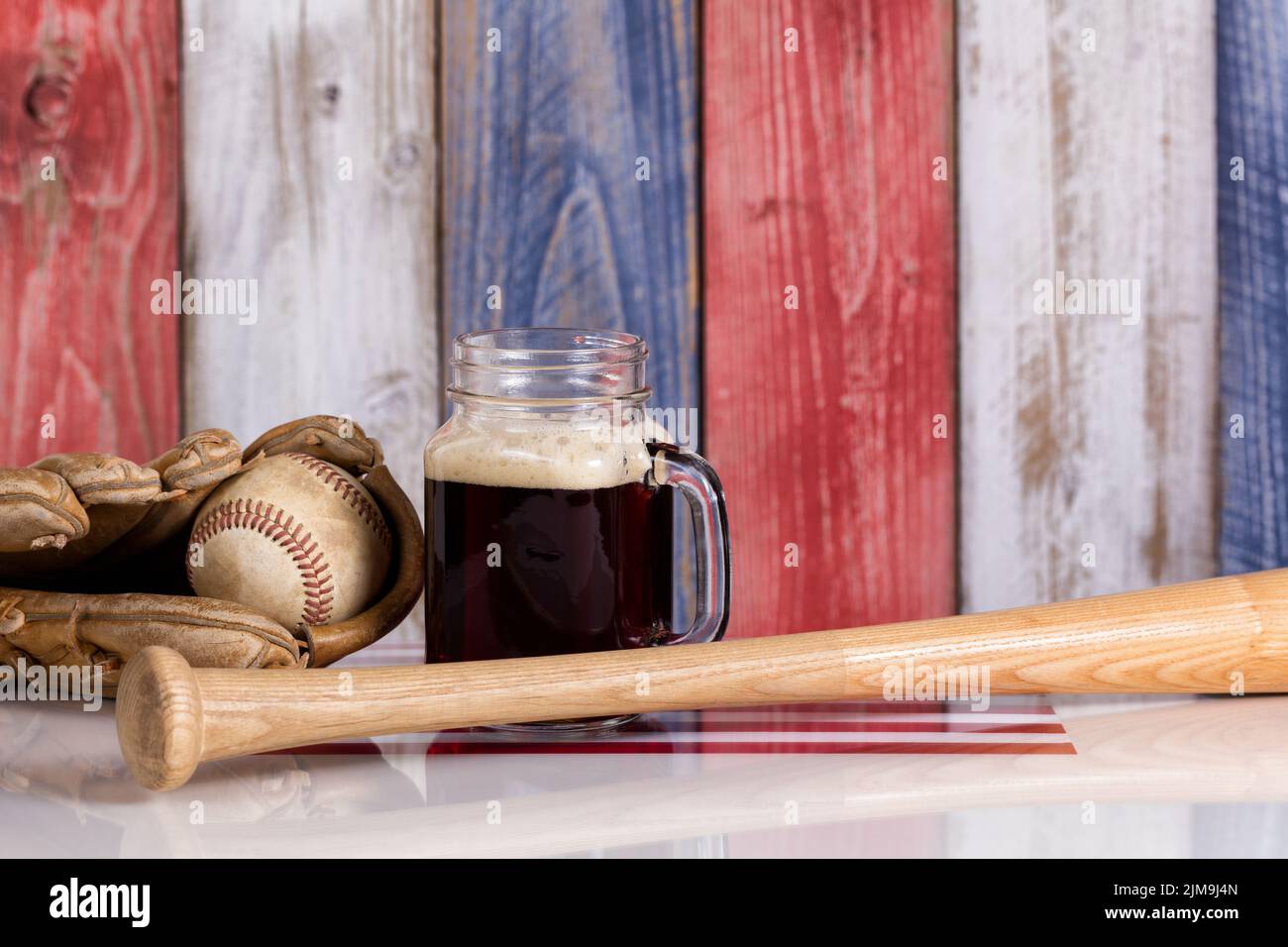 Cerveza oscura y cosas de béisbol con tablas de madera desteñidas pintadas en los colores nacionales de los Estados Unidos Foto de stock