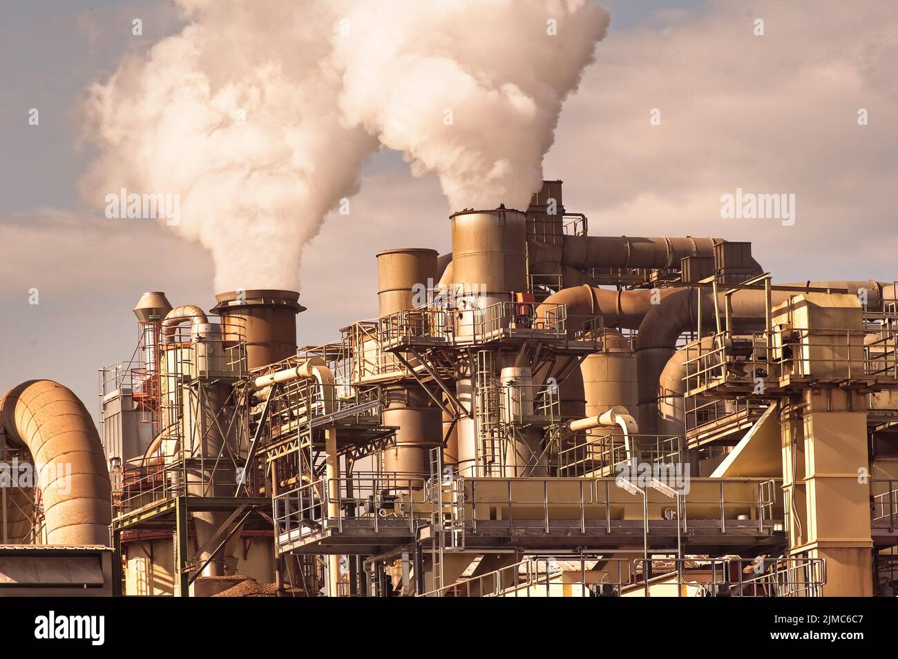 Chimeneas ahumadoras Tuberías y silos de un complejo químico de una fábrica Foto de stock