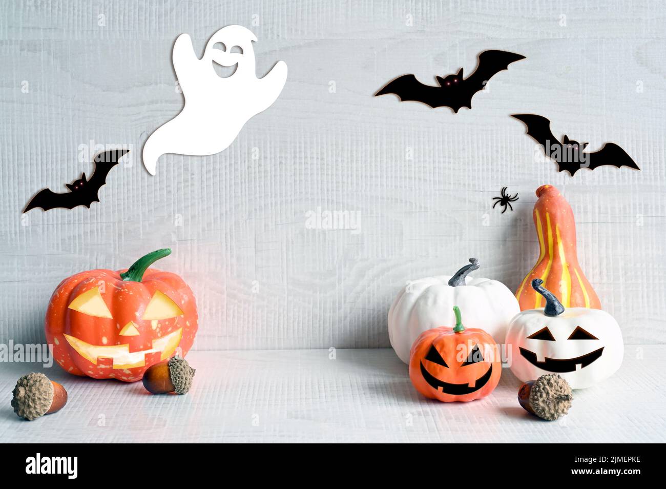 Decoraciones de Halloween sobre fondo gris pastel. Concepto de Halloween. Calabaza, araña, murciélago y fantasma. Foto de stock