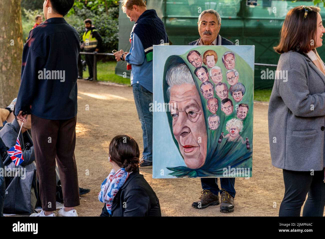 Un artista local sostiene una pintura con un retrato de la reina junto con 14 primeros ministros que han servido durante su reinado, Londres, Reino Unido. Foto de stock