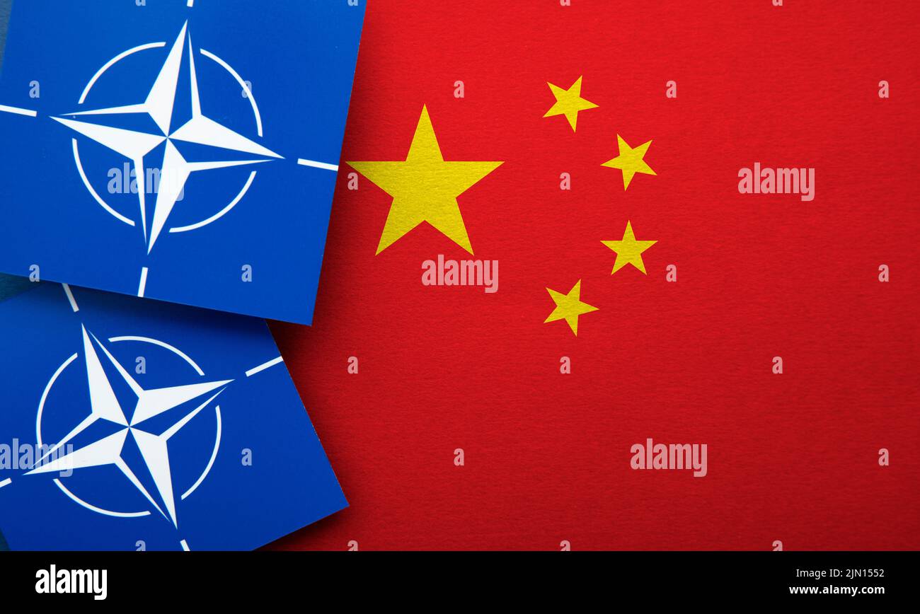 LONDRES, Reino Unido - Agosto de 2022: Logotipo de alianza militar de la Organización del Tratado del Atlántico Norte (OTAN) en una bandera de China Foto de stock