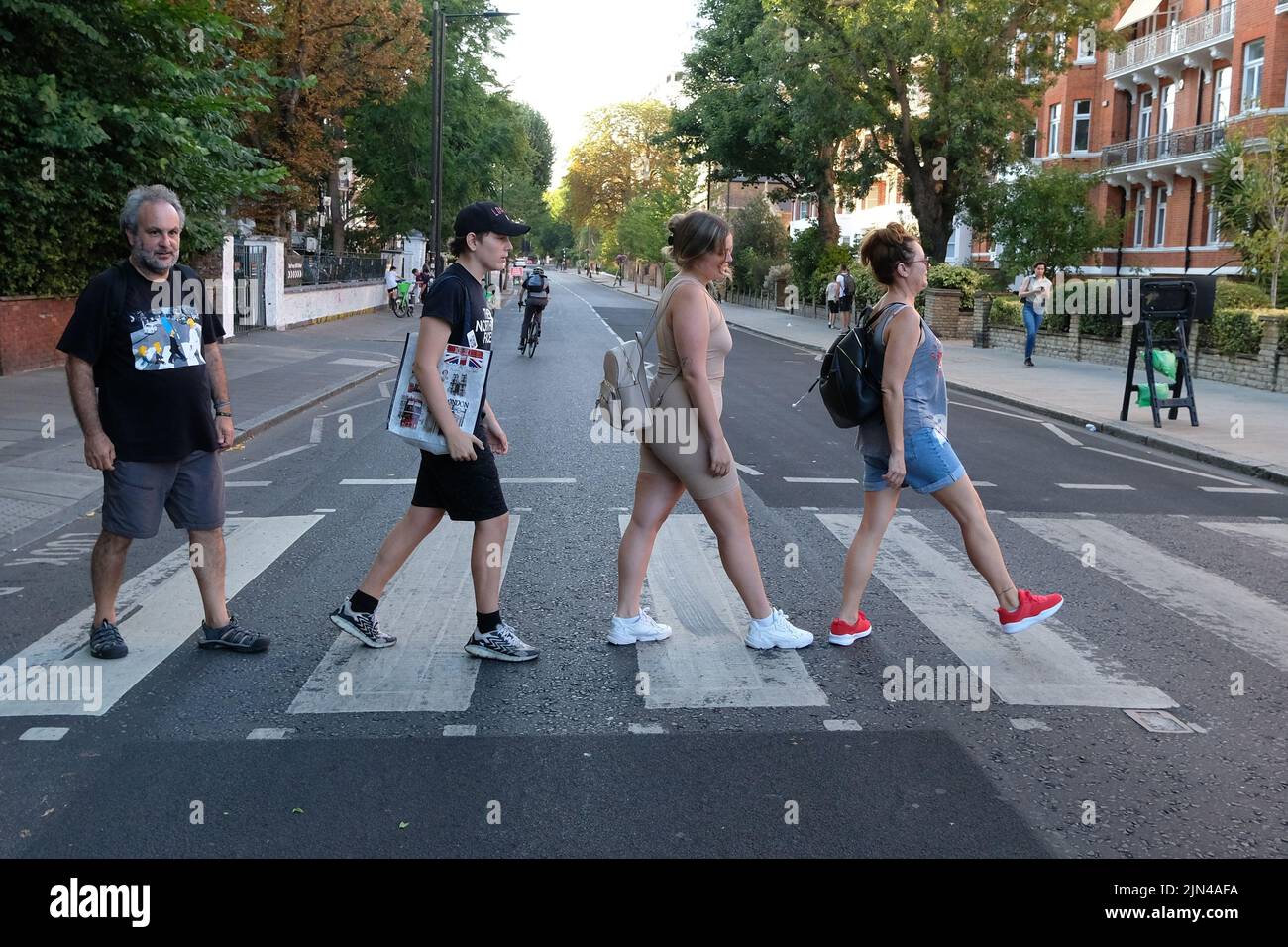 Londres, Reino Unido, 8th de agosto de 2022. Los fans de los Beatles posan para las fotos en el cruce utilizado por la banda hace 53 años hasta el día que fue utilizado en un rodaje fotográfico para la portada del álbum 'Abbey Road'. En la mañana del 8th de agosto de 1969, el fotógrafo Iain Macmillan tomó sólo seis fotografías del grupo caminando por el cruce de cebra que está cerca del estudio de grabación. Crédito: Fotografía de la undécima hora/Noticias vivas de Alamy Foto de stock