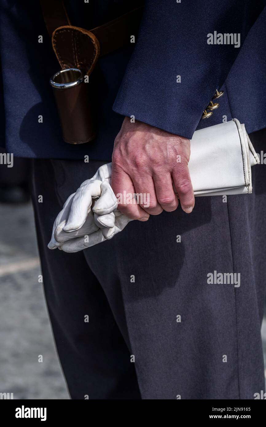 Un veterano maduro que sostiene guantes de cuero blanco en el Military Day en Trebah Garden en Cornwall en el Reino Unido. Foto de stock