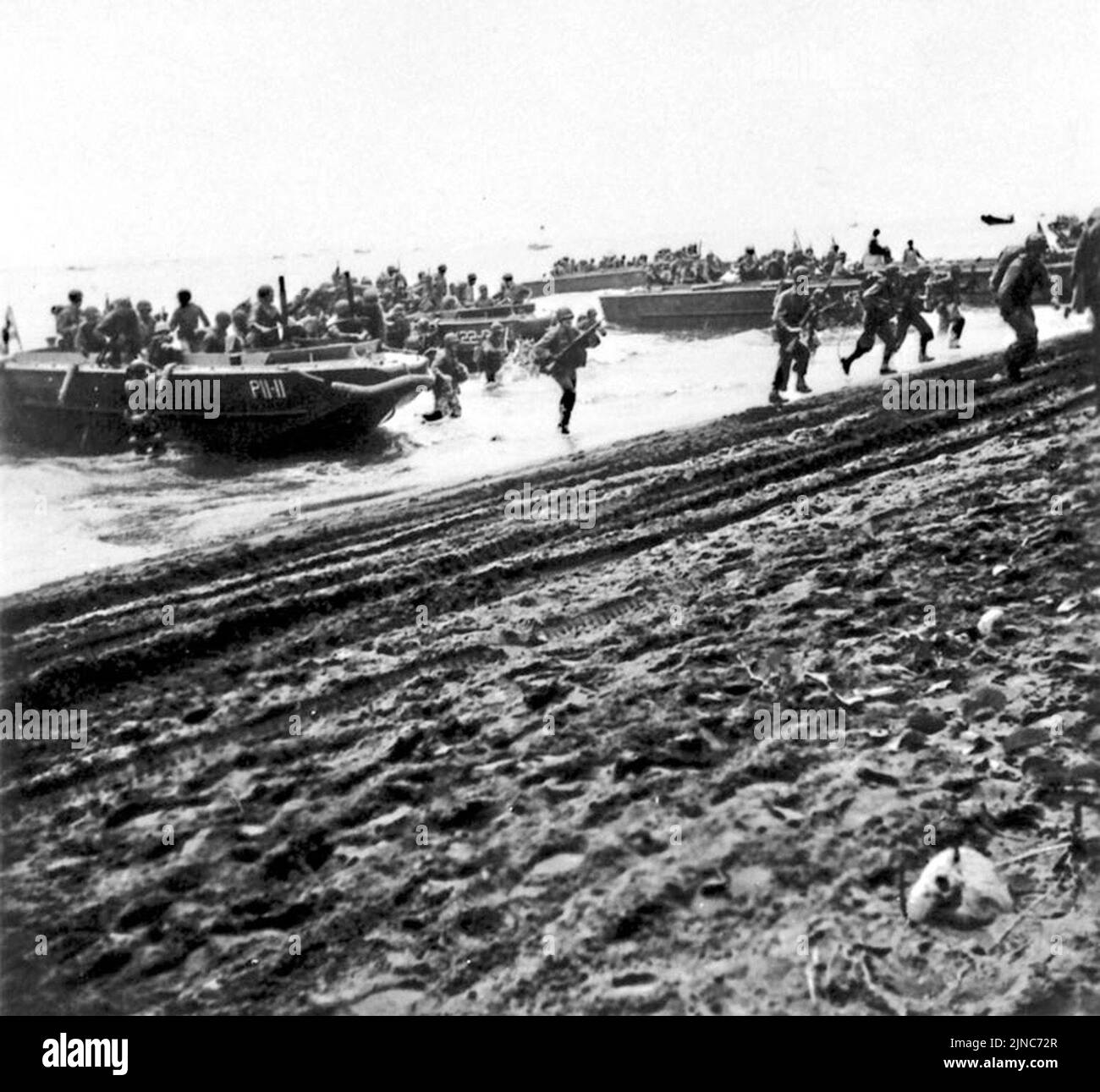 Los Marines de EE.UU. Desembarcan de su embarcación en la playa de Guadalcanal el 7 de agosto de 1942. Foto de stock