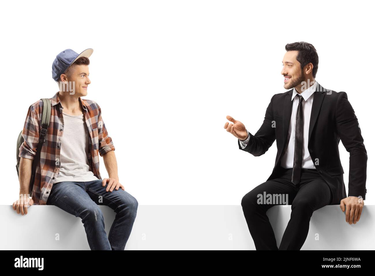 Hombre de negocios hablando con un estudiante sentado en un panel en blanco aislado sobre fondo blanco Foto de stock