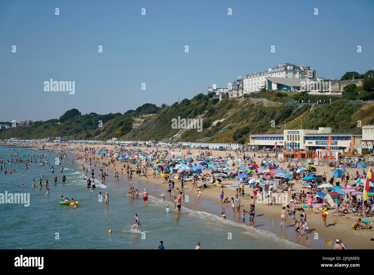 La gente disfruta del calor en la playa de Bournemouth, Dorset. Está previsto que se declare una sequía en algunas partes de Inglaterra el viernes, con temperaturas que alcanzarán los 35C grados, lo que hace que el país sea más caliente que algunas partes del Caribe. Fecha de la foto: Viernes 12 de agosto de 2022. Foto de stock