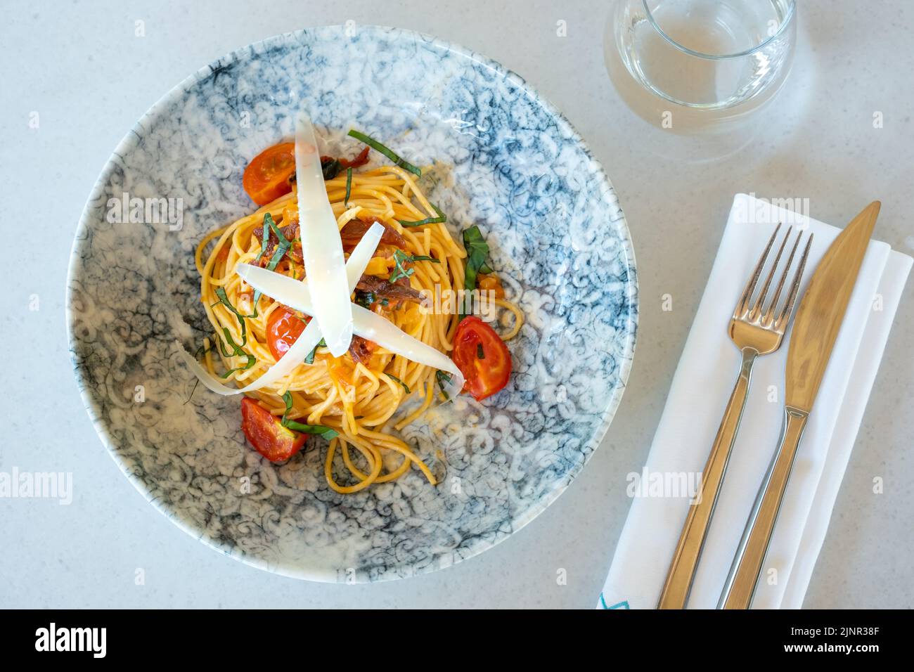 Espaguetis con salsa picante, pimiento y queso parmesano rallado Foto de stock