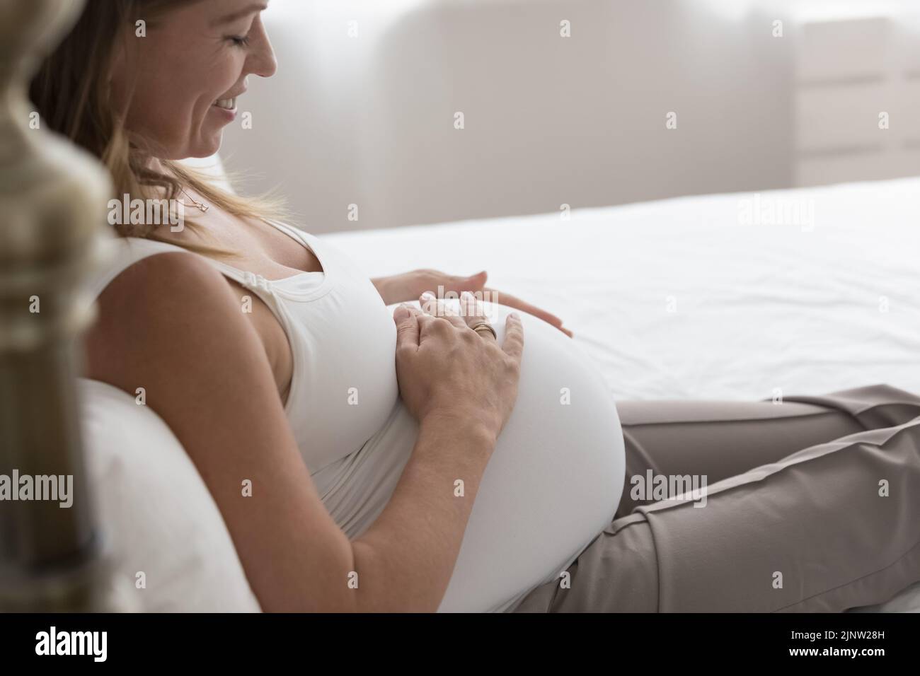 Recortada Toma afectuosa madre mujer embarazada toca el vientre grande Foto de stock