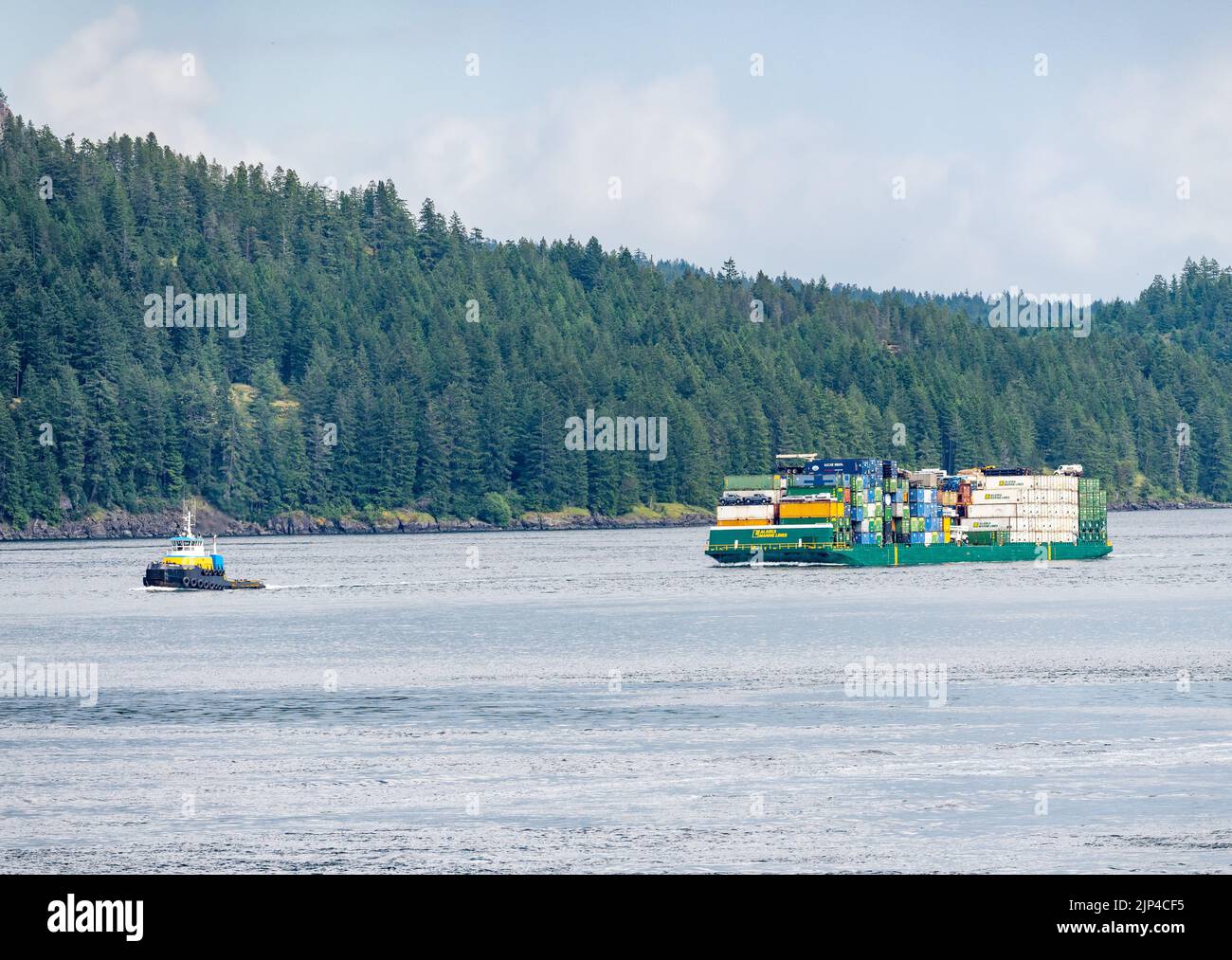 Campbell River, BC - 11 de junio de 2022: Contenedores apilados en la barcaza de Alaska Marine Lines en Discovery Passage Foto de stock