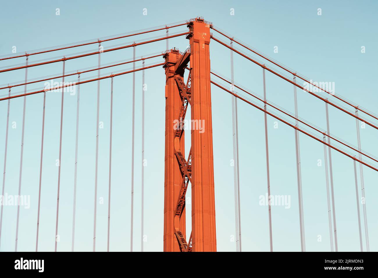 Icónico puente colgante naranja y rojo sobre el río Tajo en Lisboa, Portugal. Puente 25 de Abril, 25th de Abril Puente a la hora dorada del atardecer. Foto de stock