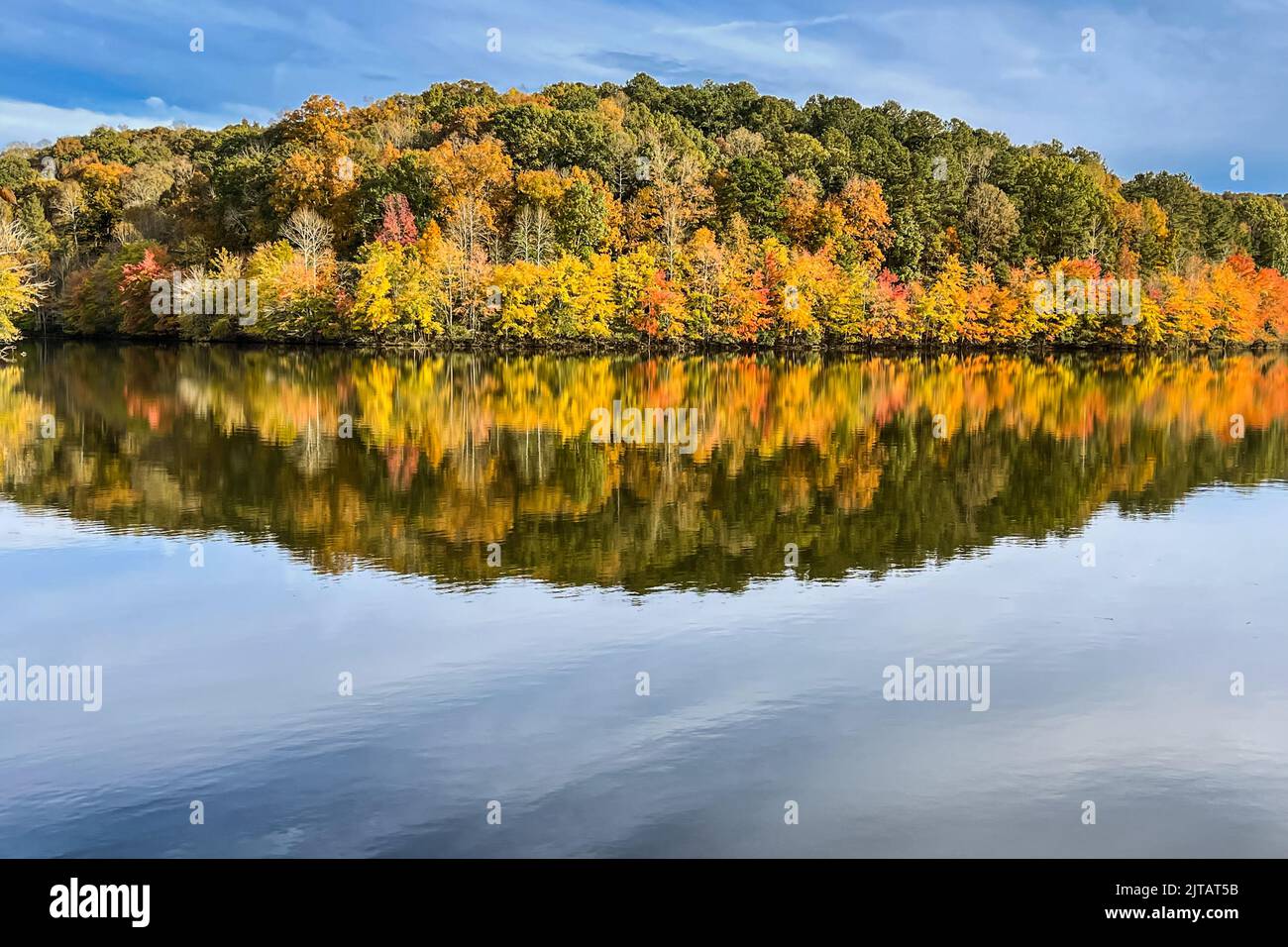 Los brillantes colores del follaje otoñal se reflejan en la superficie del lago North Georgia. Foto de stock
