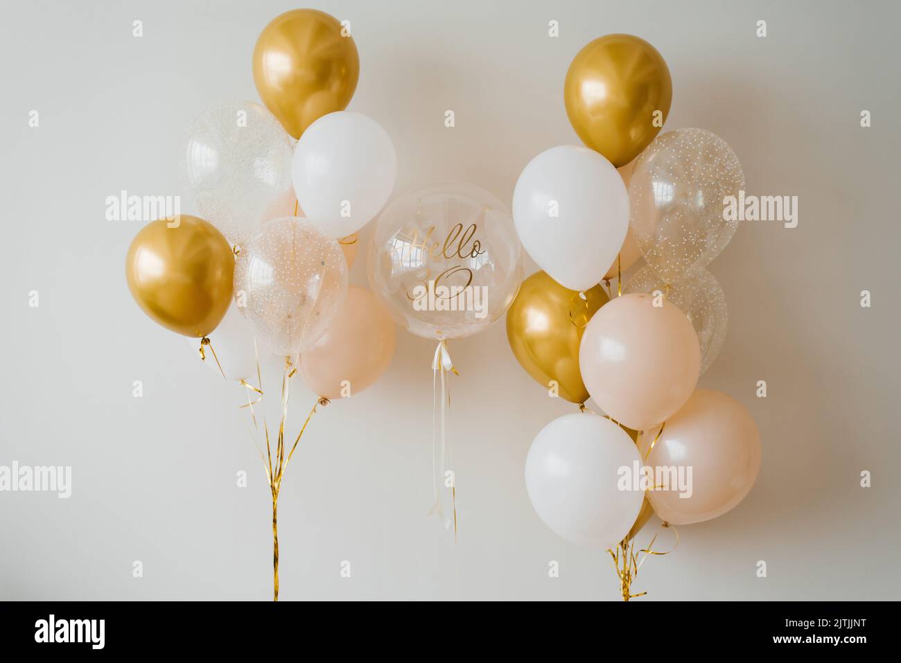 Globos festivos de helio en oro y blanco para el 30th aniversario Foto de stock