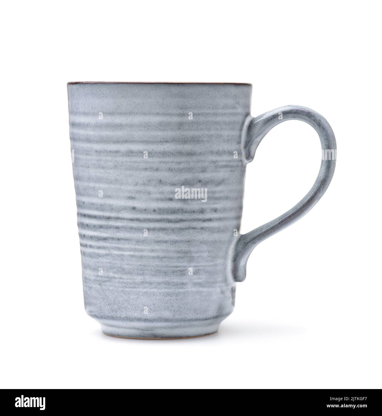 Vista lateral de la taza de café hecha a mano de cerámica aislada sobre blanco Foto de stock