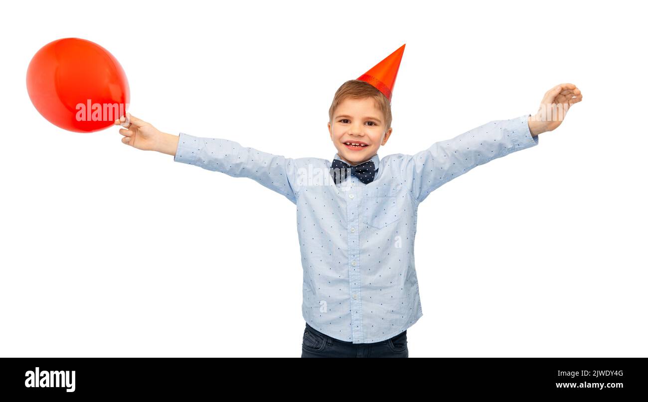 niño pequeño en sombrero de fiesta de cumpleaños con globo azul Foto de stock