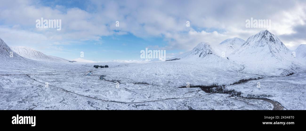 Épica imagen de paisaje aéreo en aviones teledirigidos de Stob Dearg y Glencoe en las Tierras Altas de Escocia durante las profundas nevadas y los hermosos cielos azules Foto de stock