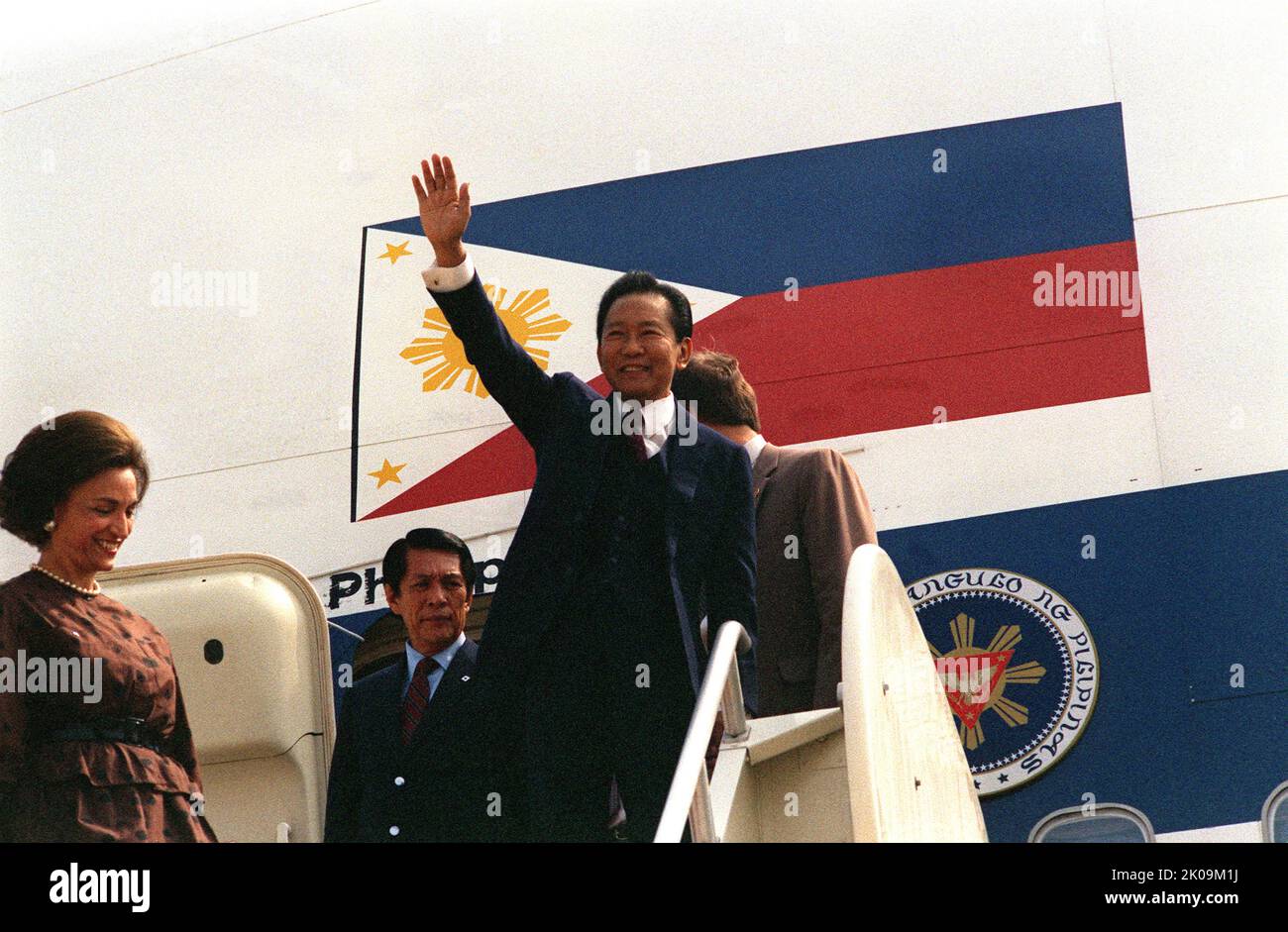 El Presidente Ferdinand E. Marcos de Filipinas, seguido por el Ministro de Defensa Juan Enrile, se detiene para saludar a la gente que espera darle la bienvenida desde un PAL 747 para una visita a Washington D.C. Foto de stock