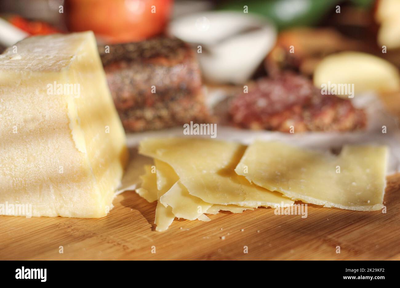 Salami de Peppercorn en bandeja con queso inglés e irlandés, manzanas en rodajas y especias en